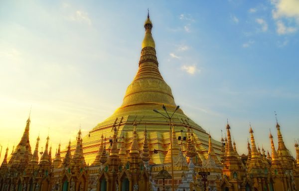 The gilded Shwedagon Pagoda glowing at dusk in Yangon, Myanmar The gilded Shwedagon Pagoda glowing at dusk in Yangon, Myanmar