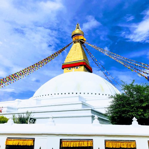 The white dome and golden spire of Boudhanath stupa in Kathmandu