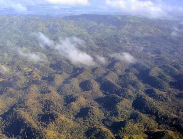 The Chocolate Hills of Bohol, Philippines, under a blue sky