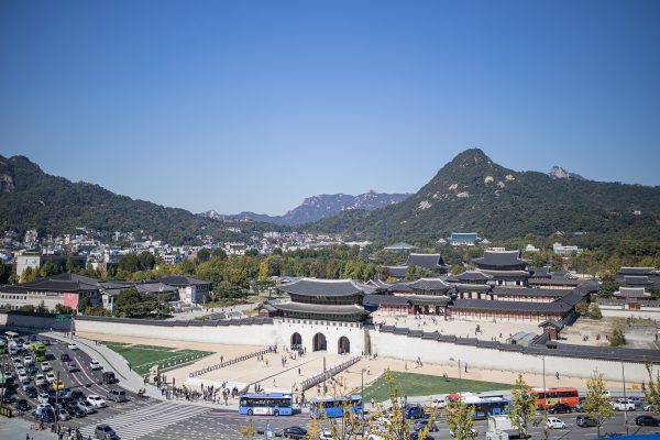 Gyeongbokgung Palace gate in Seoul with traditional hanbok visitors Gyeongbokgung Palace gate in Seoul with traditional hanbok visitors